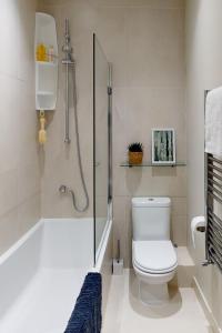 a bathroom with a shower with a toilet and a glass shower at Madison Hill - White Hill House 3 - 1 bedroom flat in London