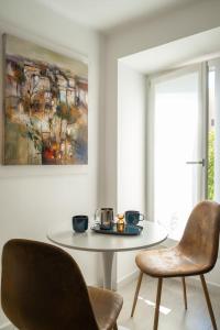 a dining room with a table and two chairs at URBAN HOME in Bari