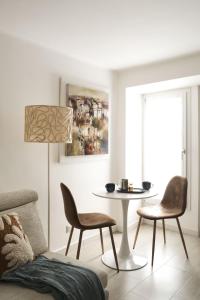a living room with a table and chairs at URBAN HOME in Bari