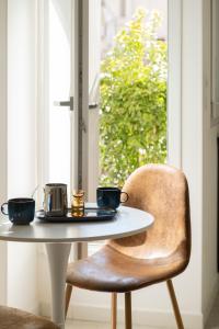 a table with two cups on it next to a window at URBAN HOME in Bari