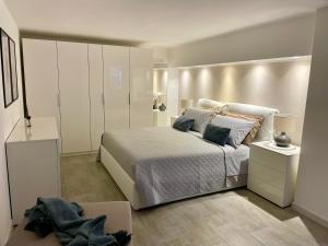 a bedroom with a large bed and white cabinets at URBAN HOME in Bari