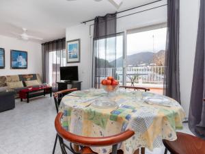 a dining room with a table with a bowl of fruit on it at Holiday Home El Morer by Interhome in Llança