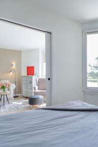 a bedroom with a bed and a living room at Louis in Westerland (Sylt)