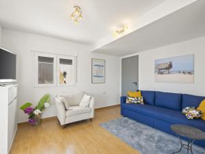 ein Wohnzimmer mit einem blauen Sofa und einem Sessel in der Unterkunft Villa La Vista by Interhome in Benissa + 56 Fotos