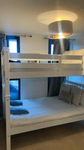 a bunk bed in a room with a white bunk bed at Fernando flats in London