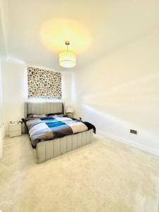 a bedroom with a bed in a white room at Home far from home in central London in London