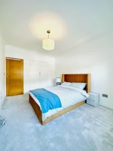 a bedroom with a large bed with a wooden headboard at Home far from home in central London in London
