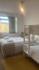 a bedroom with two bunk beds and a window at Fernando flats in London