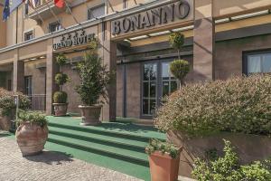 a building with potted plants in front of it at Grand Hotel Bonanno in Pisa