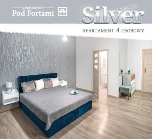 Apartamenty Pod Fortami في برزيميسل: غرفة نوم مع سرير بلوحة راس زرقاء