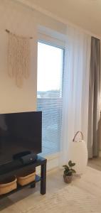 a living room with a table and a window at Studio 12 floor, Puijo landscape, Free parking in Kuopio