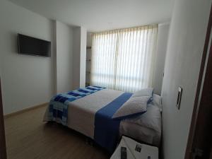 Postel nebo postele na pokoji v ubytování Hospedaje Tunja