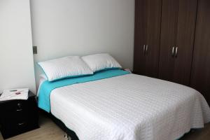 Postel nebo postele na pokoji v ubytování Hospedaje Tunja