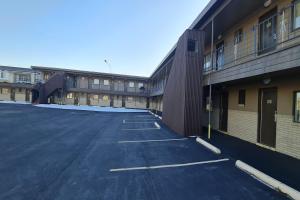 an empty parking lot in front of a building at DuBois Manor Motel by OYO in DuBois