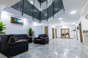 a lobby with couches and chairs in a building at Crownsville Hotel - Airport Road in Port Harcourt