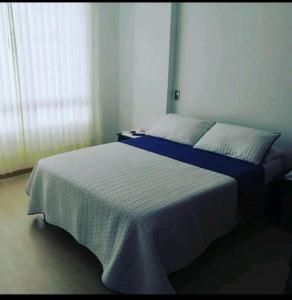 Postel nebo postele na pokoji v ubytování Hospedaje Tunja