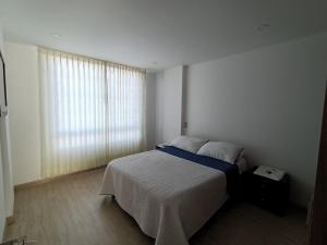 Postel nebo postele na pokoji v ubytování Hospedaje Tunja