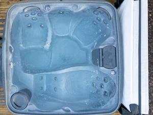 a suitcase filled with water on a wooden table at Holiday Home Glenfiddich by Interhome in Aviemore