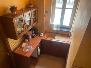 a small kitchen with a sink and a window at Pension Isabo in Nafplio +67 photos