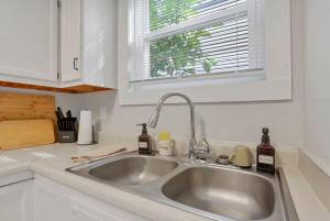 a kitchen counter with a sink and a window at The Scarlet Adventure in Columbus