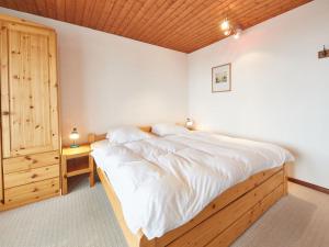ein Schlafzimmer mit einem großen Bett und einer Holzdecke in der Unterkunft Apartment Flache 107 by Interhome in Les Collons