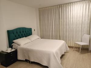 Postel nebo postele na pokoji v ubytování Hospedaje Tunja
