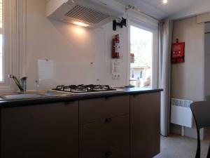 a kitchen with a stove and a sink and a window at Holiday Home Bella Italia-8 by Interhome in Peschiera del Garda