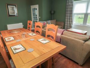 a living room with a wooden table and chairs at Salmon Cottage in Berwick-Upon-Tweed