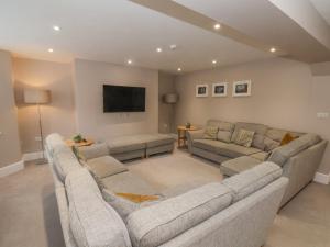 a living room with couches and a flat screen tv at Station House in Scarborough