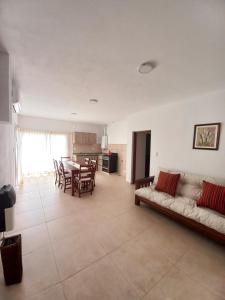 a living room with a couch and a table at La Juana in Almafuerte +3 photos