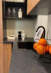 a kitchen with oranges in a basket on a counter at Bruno Apartment in Ariano Irpino