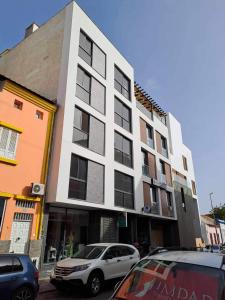 a white car parked in front of a building at Santos House Praia in Praia