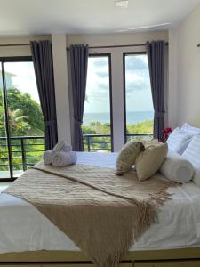 a bedroom with a bed with a view of the ocean at SEASUN Villa Haad Tien in Haad Tian