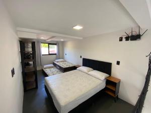 a bedroom with a bed and a couch in it at Lofts Meia Morada SFS in São Francisco do Sul