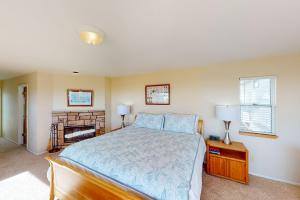 a bedroom with a bed and a fireplace at Ocean Mornings in Cayucos