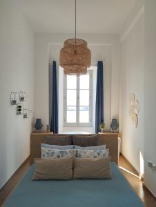 a bedroom with a bed with a large window at Aegina Port Apt 4 in Aegina Town