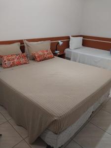 two beds sitting next to each other in a room at Leme Plaza Hotel in Leme