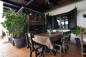 a dining room with a table and chairs at Casa Lancelot in Tinajo