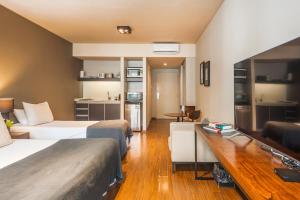 een hotelkamer met twee bedden en een bureau bij Central Location Full Amenities heart Palermo Soho powered by Argenhost -T107- in Buenos Aires +56 foto's