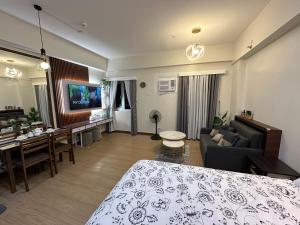 a hotel room with a bed and a living room at Apartment Condotel at Hope Residences Trece Martires Cavite in Trece Martires