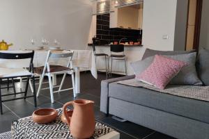 - un salon avec un canapé et une table avec des chaises dans l'établissement Bosa Apartments Episcopio 1, à Bosa
