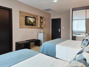 Rúm í herbergi á Hotel Perla Spondylus