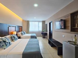 Rúm í herbergi á Hotel Perla Spondylus