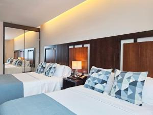 Rúm í herbergi á Hotel Perla Spondylus