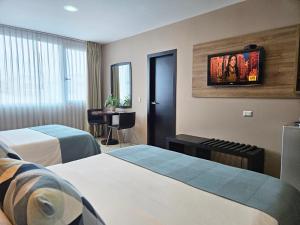 Rúm í herbergi á Hotel Perla Spondylus