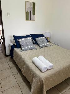 a bed with two pillows and two towels on it at Frente al mar loft in Puntarenas