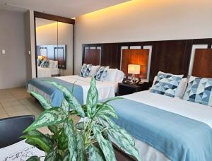 Rúm í herbergi á Hotel Perla Spondylus