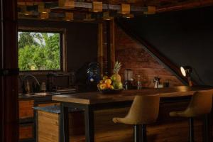 a kitchen with a counter with a bowl of fruit on it at BooHouse - A Wild Cabin in Colombia in Caicedonia