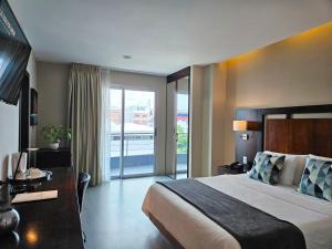 Rúm í herbergi á Hotel Perla Spondylus