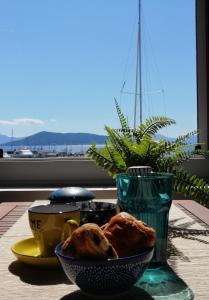 a bowl of bread sitting on a table with a window at Aegina Port Apt 4 in Aegina Town